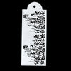 A white plastic cake stencil featuring intricate floral and leaf designs on a black background.