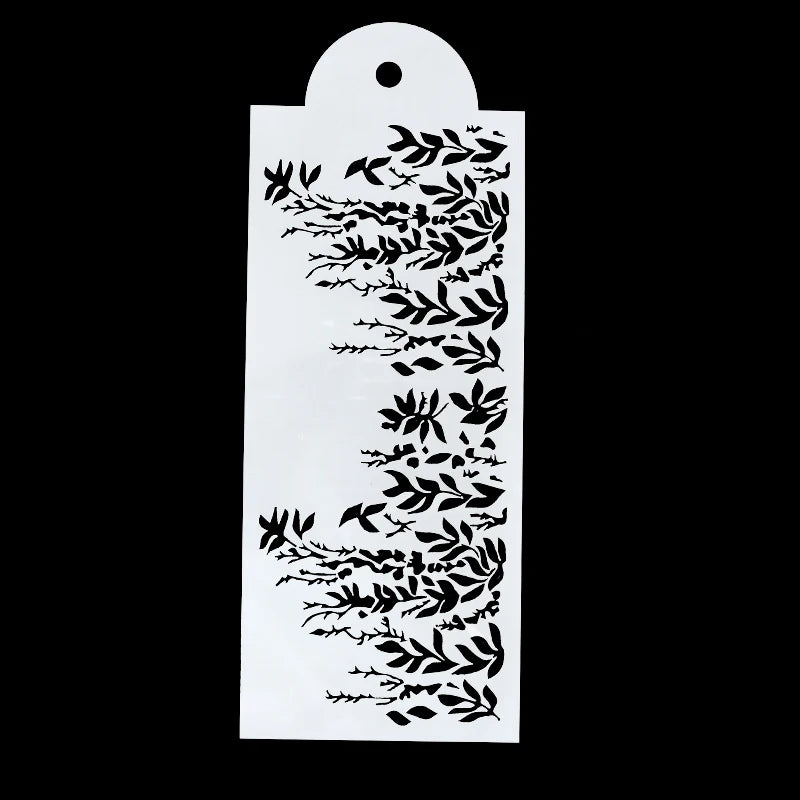 A white plastic cake stencil featuring intricate floral and leaf designs on a black background.