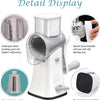 Detail display of a white rotary kitchen grater and slicer showing various features like the feeding port, spiral handle, and
