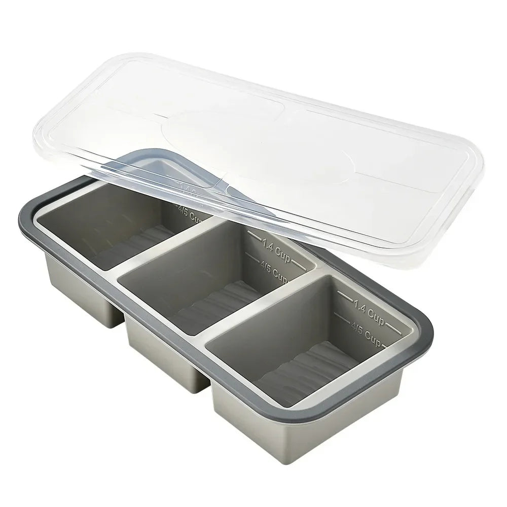 A clear silicone food storage tray with a lid, containing multiple compartments for food.