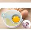 A multi-piece egg white and yolk separator set showing a yellow egg in a silicone tool over a white bowl.