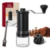 A black manual ceramic coffee grinder with an adjustable scale and a glass container, next to whole coffee beans and ground c
