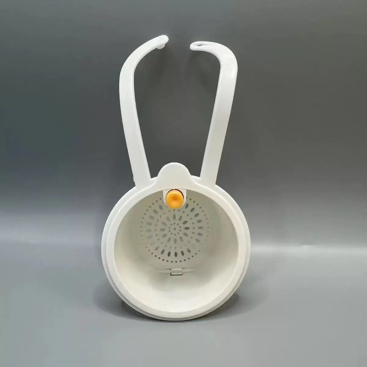 White press-type drain basket with a handle, used for kitchen or bathroom drainage.