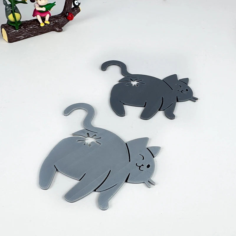 A gray silicone cat silhouette clip used for food packaging or kitchen gadgets.