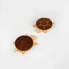 A set of solid wood turtle insulation mats or coasters with a textured brown surface.