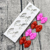 White silicone baking molds shaped like bows for chocolate cupcakes and candies