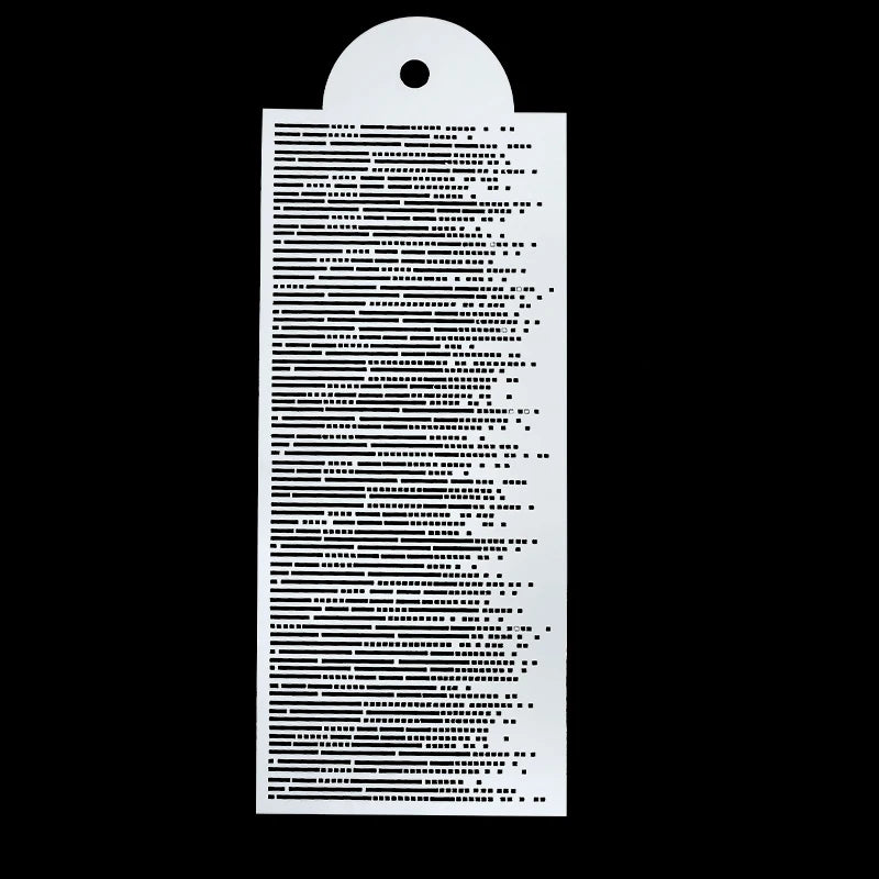 A white plastic cake stencil set with a perforated design against a black background.