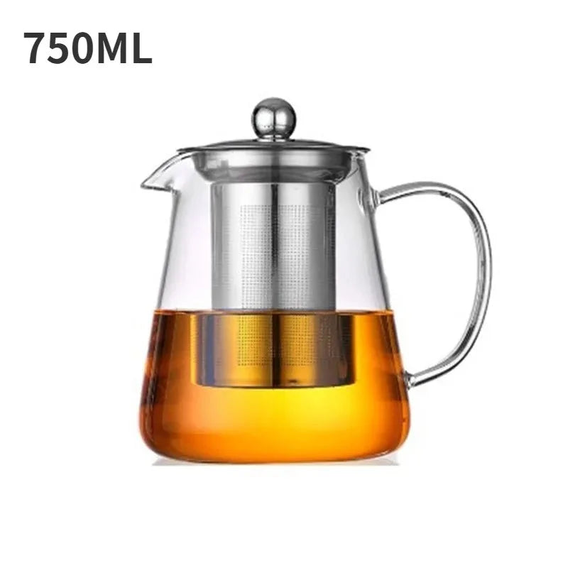 A clear glass teapot with a stainless steel infuser filled with amber-colored liquid.