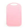 A pink non-slip plastic cutting board with a hanging handle.