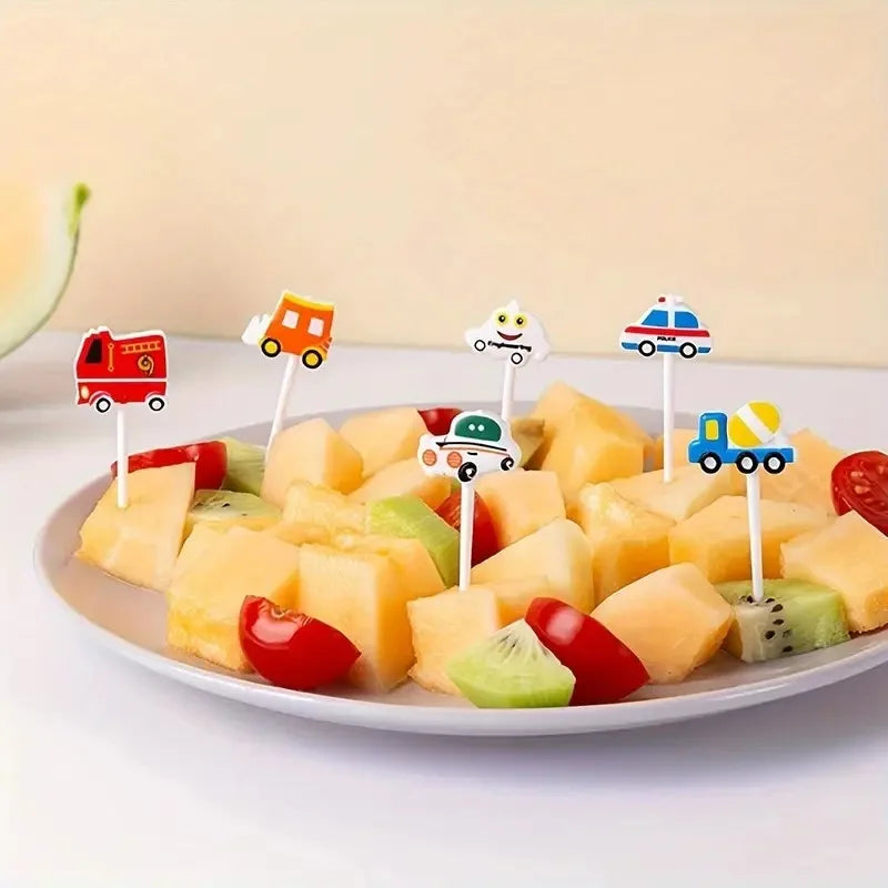A plate of diced fruit pieces arranged on skewers with cartoon animal toppers.