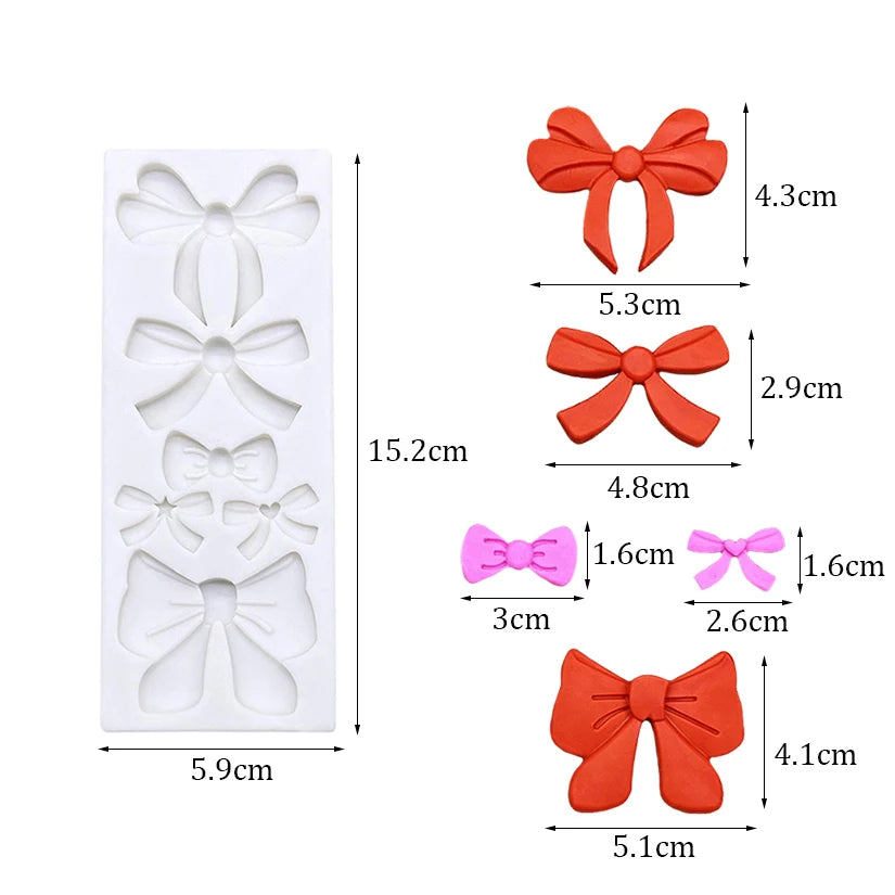 Silicone baking molds shaped like bows and butterflies in orange and pink colors