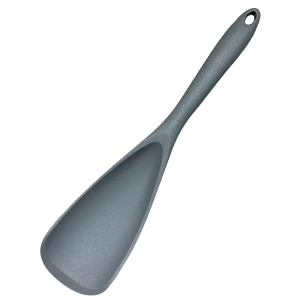 A gray heat resistant silicone stirring spoon with a tapered handle.