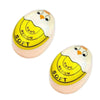 A yellow and white color-changing boiled egg timer with hard, medium, and soft settings visible.