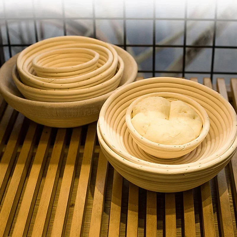 A light tan natural rattan bread proofing basket filled with dough, set on a wooden surface.