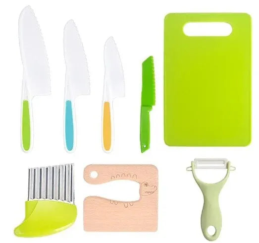 A set of plastic fruit and cake cutting tools including knives, a cutting board, and a cookie cutter.