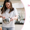 A woman is cooking a meal using a visual countdown timer with a night light on a stovetop.