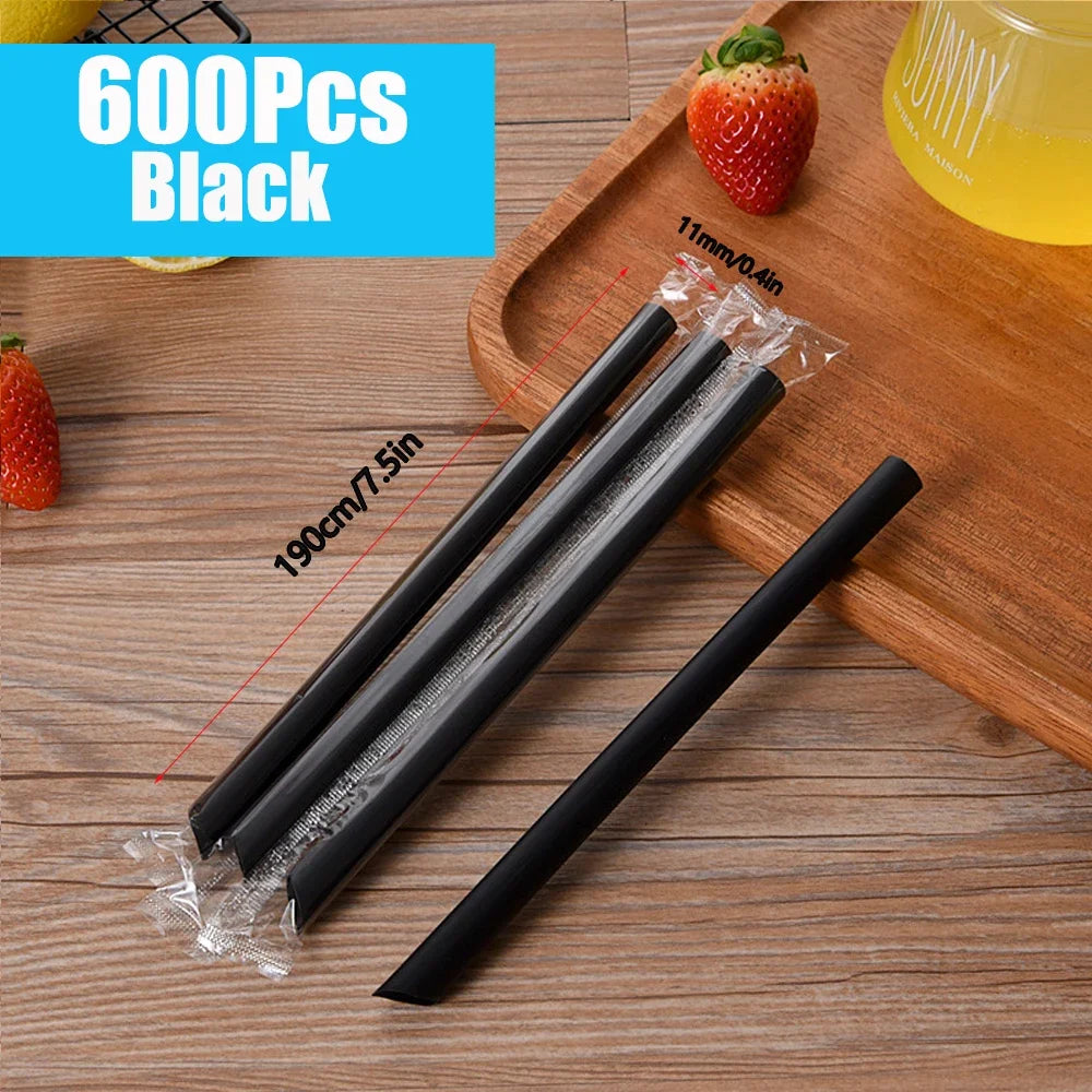 A set of 600 black reusable plastic drinking straws is displayed on a wooden board.