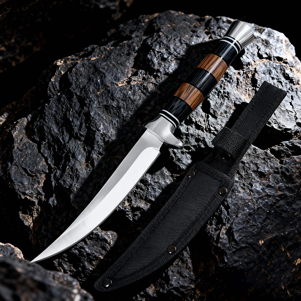 A Japanese style sashimi knife with a silver blade and wooden handle resting on a dark rock.