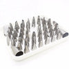 A white tray holding a set of 52 stainless steel cake decorating nozzles.