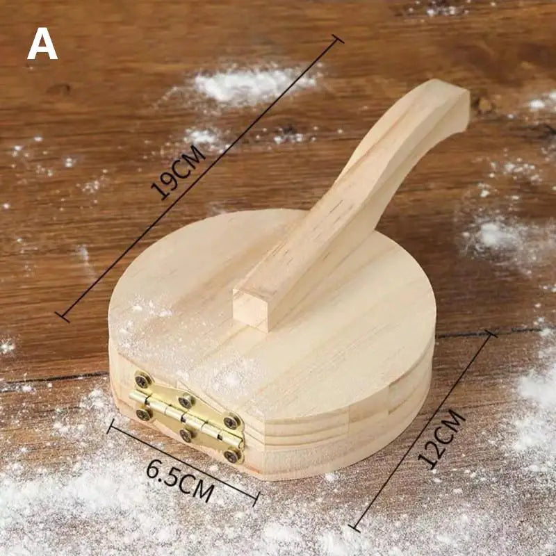 A solid wood dumpling press tool with a wooden handle and a circular base, shown on a wooden surface.