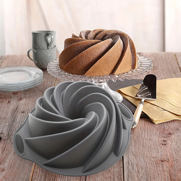 A silicone cake mold with a spiral design is shown next to a baked cake and on a wooden table.