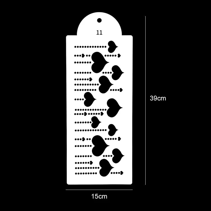 A white plastic cake stencil set with 11 decorative shapes, measuring 39cm high and 15cm wide.