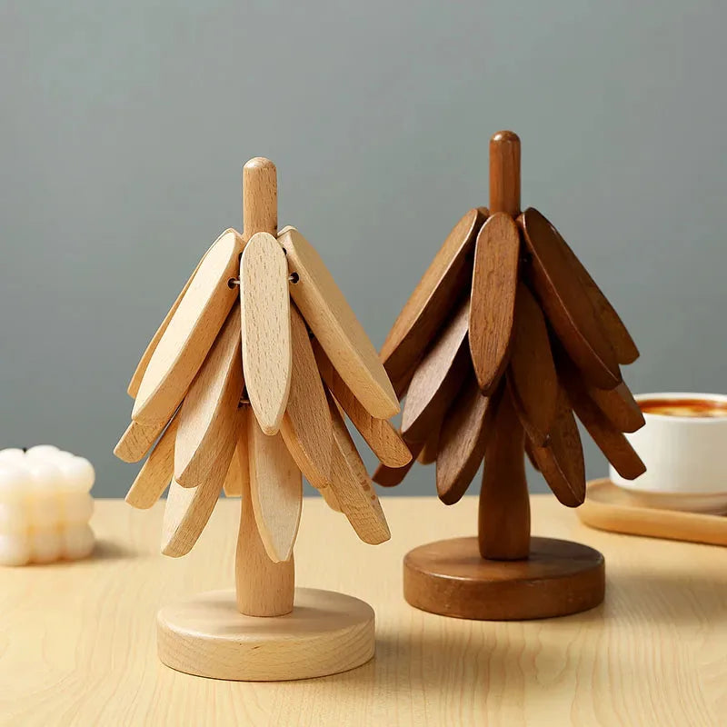A set of natural wood insulation coasters shaped like stylized evergreen trees.