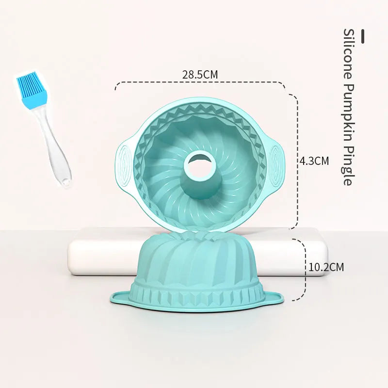 A light blue silicone baking pan set featuring a round pan and a fluted pan, with a small brush visible.