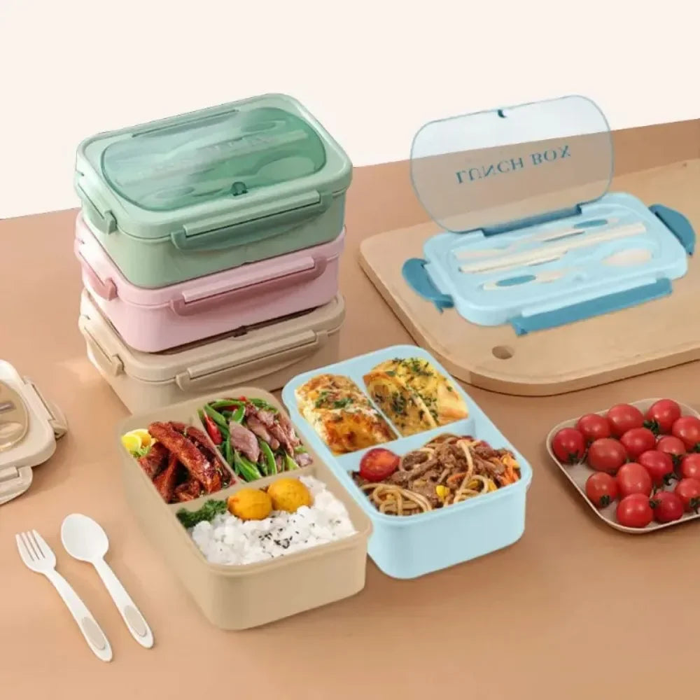 A set of leakproof bento lunch boxes in various colors with accompanying utensils and fresh food items.