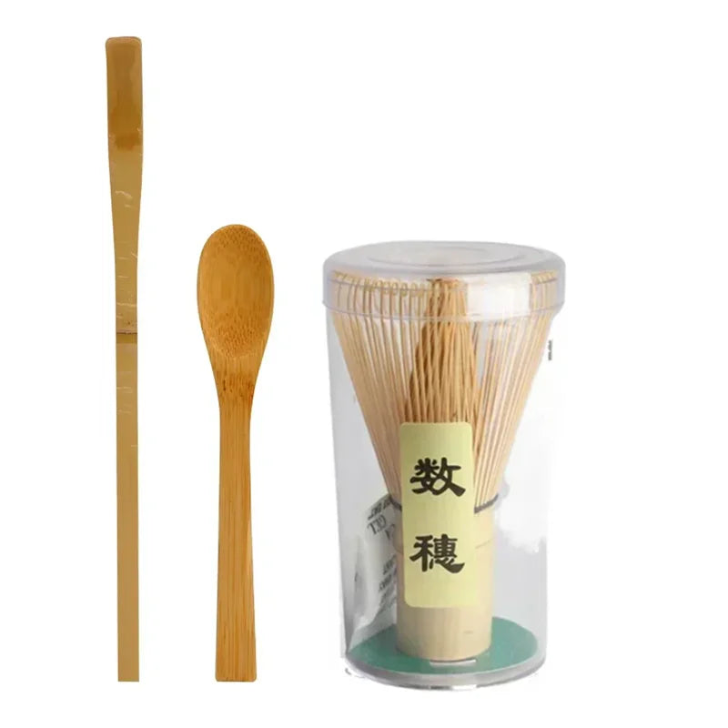 A set of bamboo and ceramic matcha tea tools including a bamboo whisk and a container filled with bamboo tea sticks.
