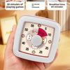 A hand holds a white visual countdown timer with a pink and orange dial showing time remaining.