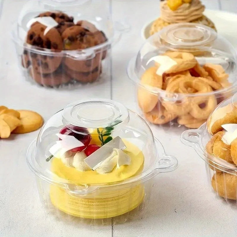 Clear disposable cake boxes filled with various baked goods like cookies and pastries