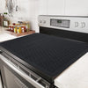 A black silicone induction cooker protector mat is shown in a kitchen setting.