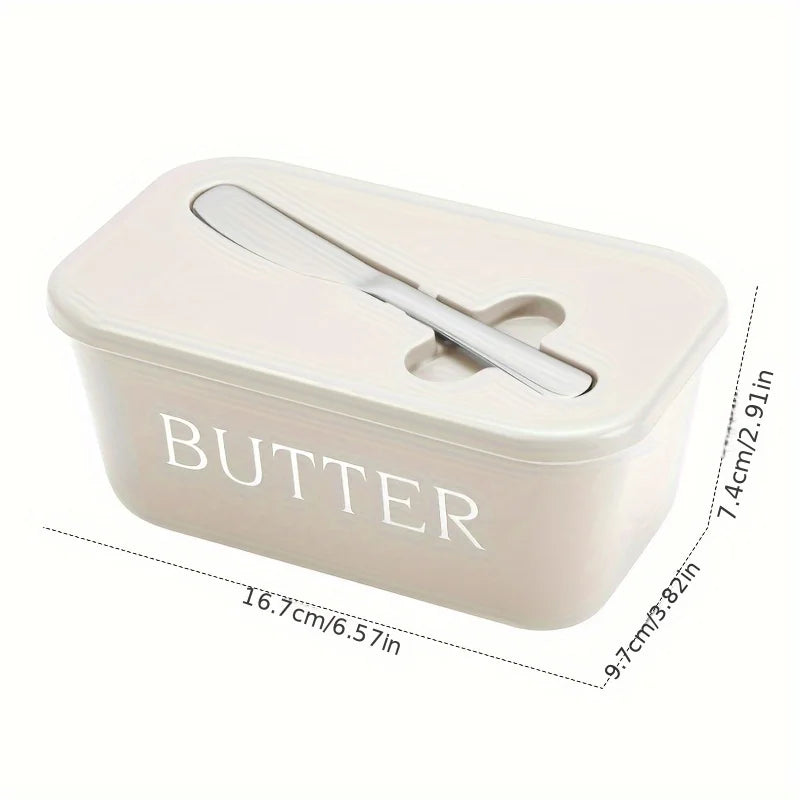 A rectangular, light beige butter storage container with a silver slicer knife resting inside.