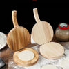 A set of solid wood dumpling press tools showing the wooden handles and circular pressing plates.