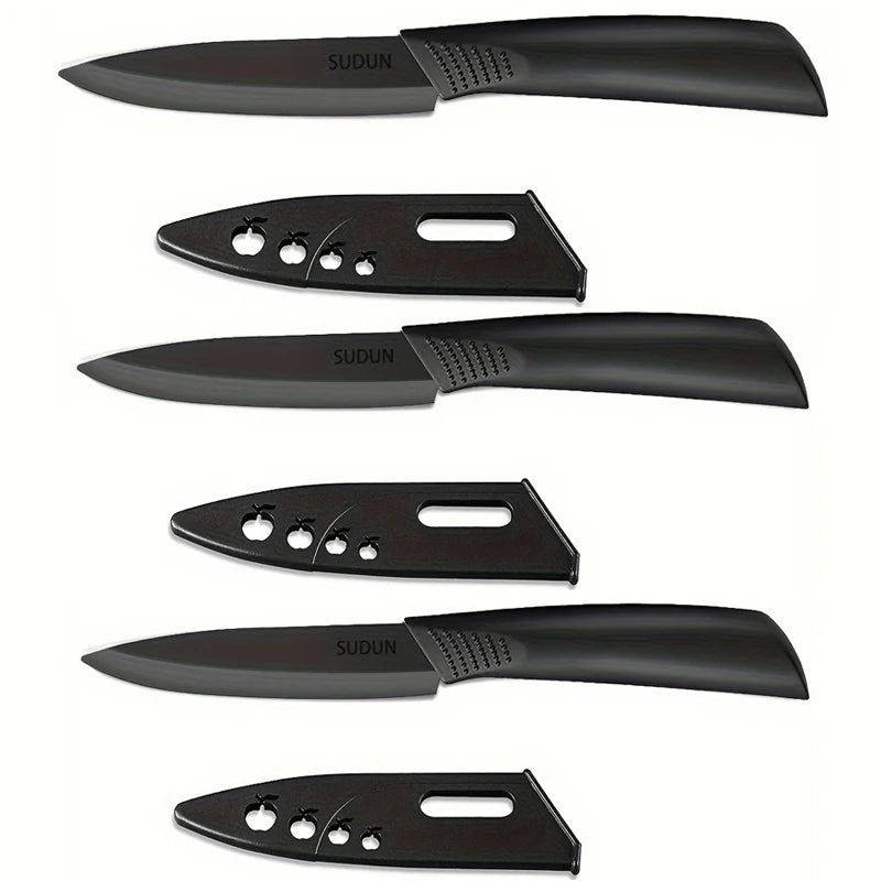 A set of four black stainless steel utility knives shown in various profiles and angles.