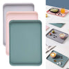 A set of rectangular serving trays in pastel pink, mint green, and dusty blue shades.