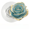 A silicone mold shaped like a blue-green rose with gold accents, used for baking.