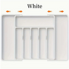 White expandable silverware drawer organizer with multiple compartments for kitchen utensils