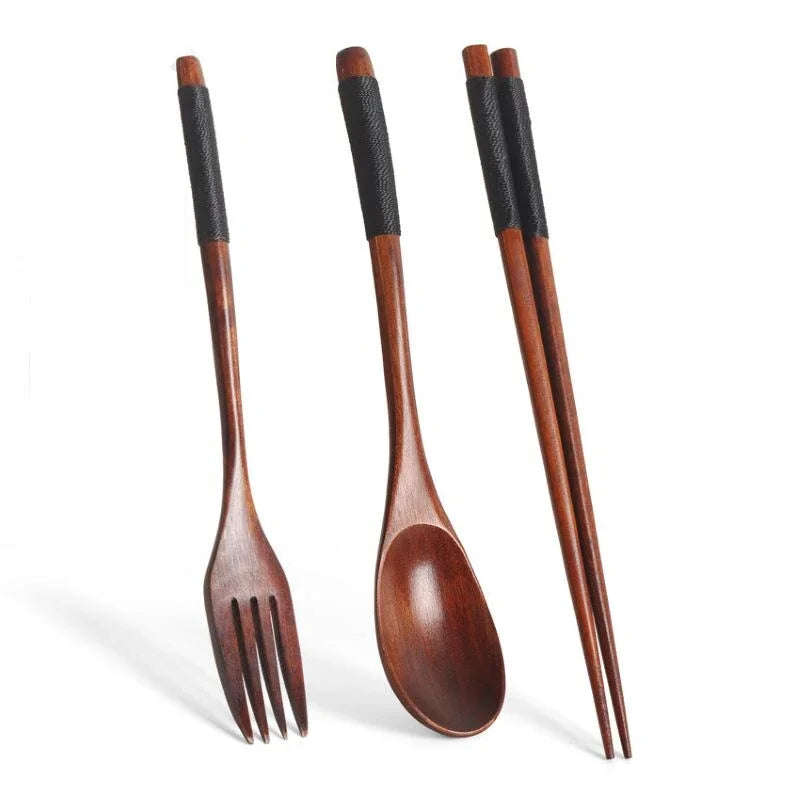 A set of three natural wooden chopsticks or spoons with black grips.