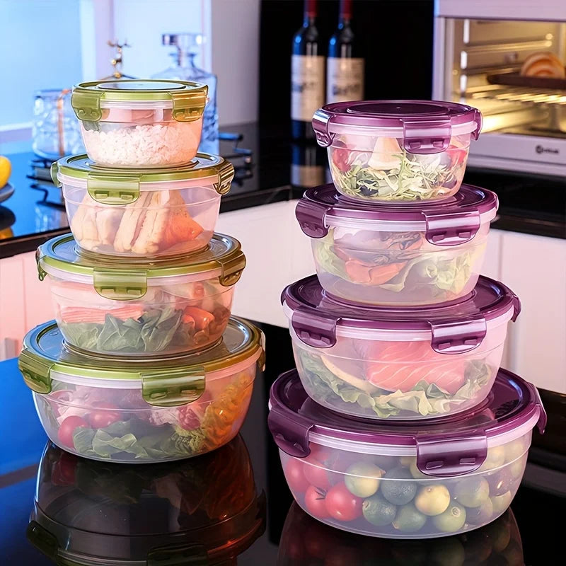 A stack of purple and green airtight food storage containers on a black countertop.