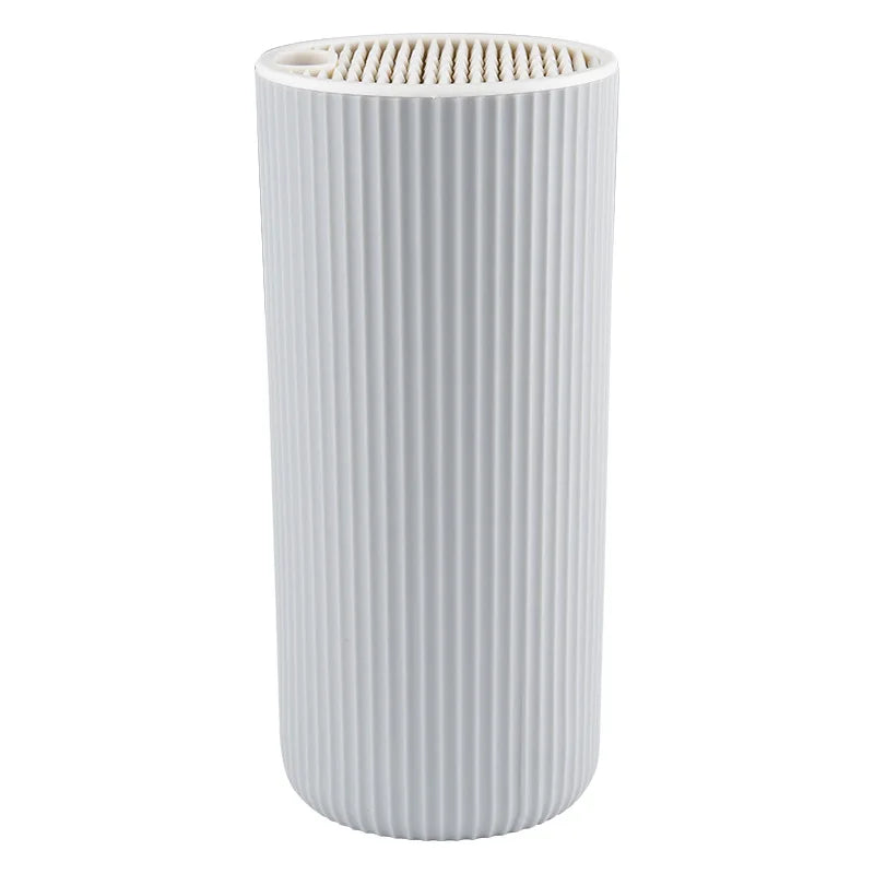 A white cylindrical knife block organizer with vertical ridges.