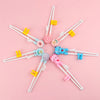 A set of cartoon animal head chopsticks in various colors and shapes arranged in a star pattern.