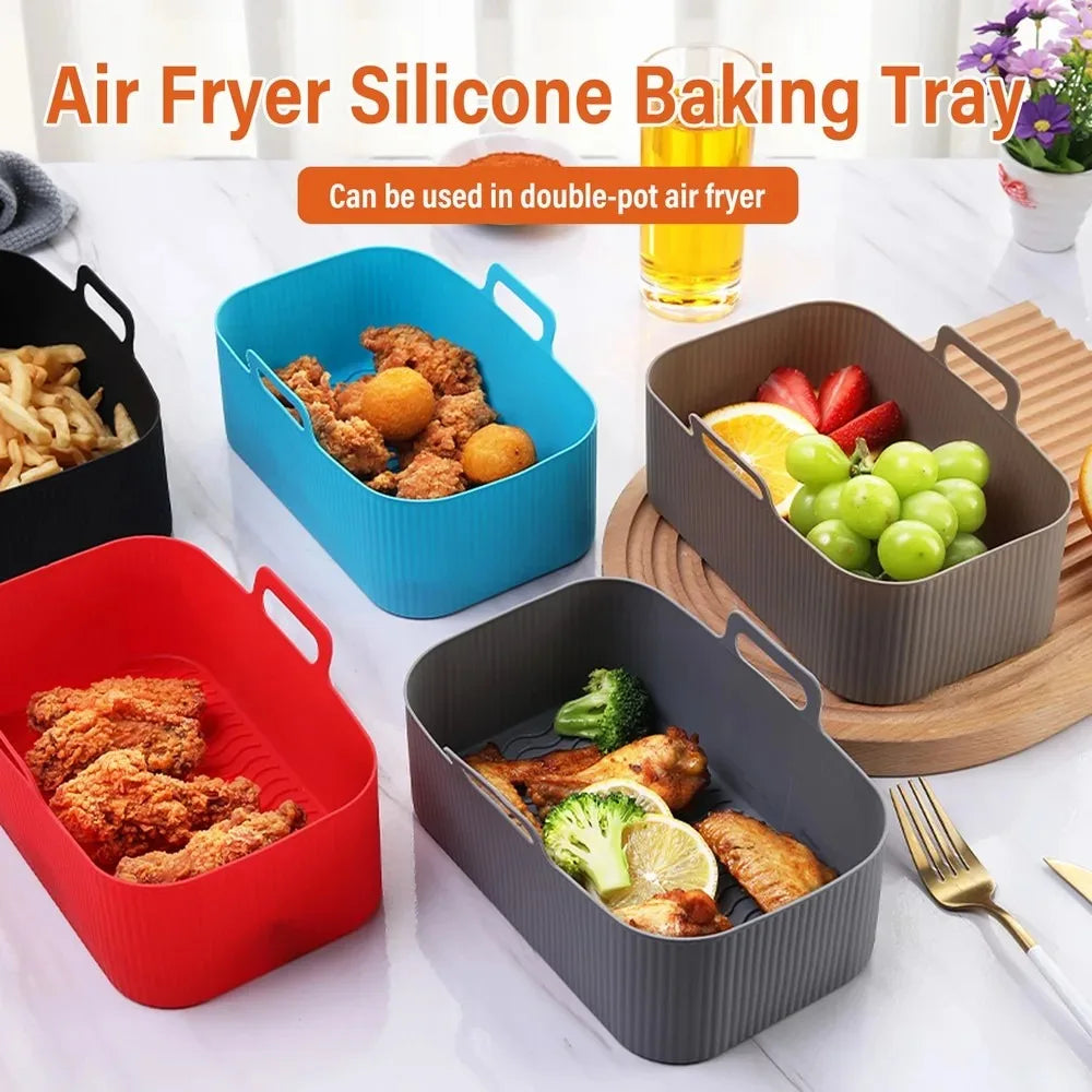 A collection of reusable silicone baking trays in red, blue, and gray are shown with food items like chicken and vegetables.