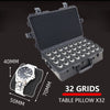 A black plastic watch storage case with a lid open, showing 32 grids and a watch.