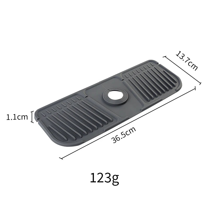 A gray silicone sink splash guard mat with dimensions 13.7cm by 36.5cm and a weight of 123g.