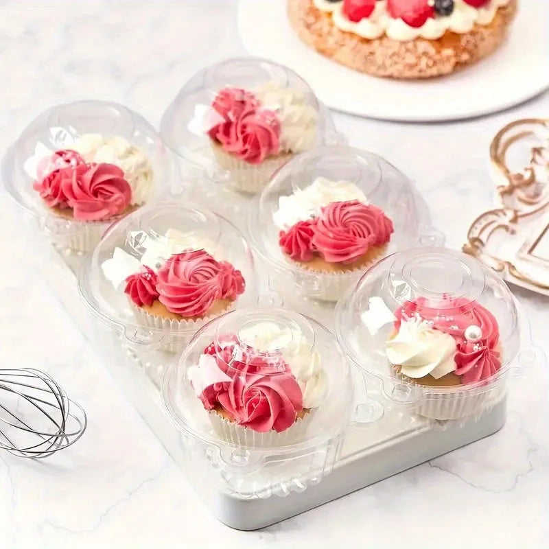 A tray of decorative disposable cake boxes filled with cream and pink frosting roses.