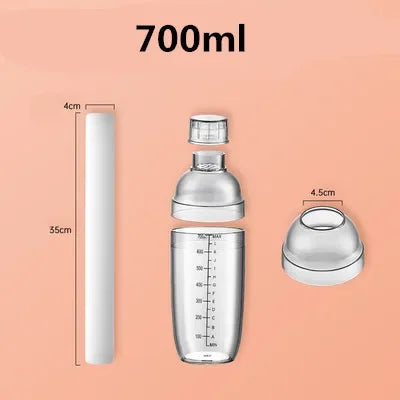 A clear plastic cocktail shaker set with a 700ml capacity and various components shown against a peach background.