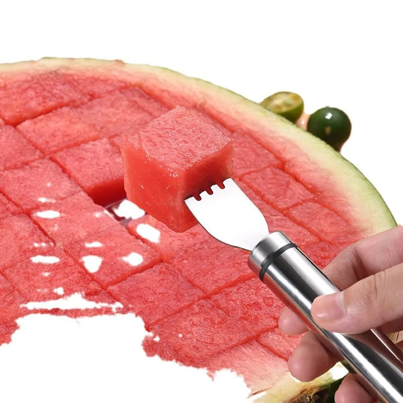 A hand uses a stainless steel tool to cut a cube of watermelon from a slice of fruit.
