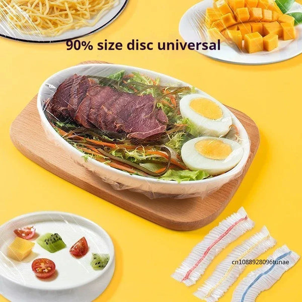 A wooden bowl filled with sliced roast beef, eggs, and greens, next to reusable food storage bags.